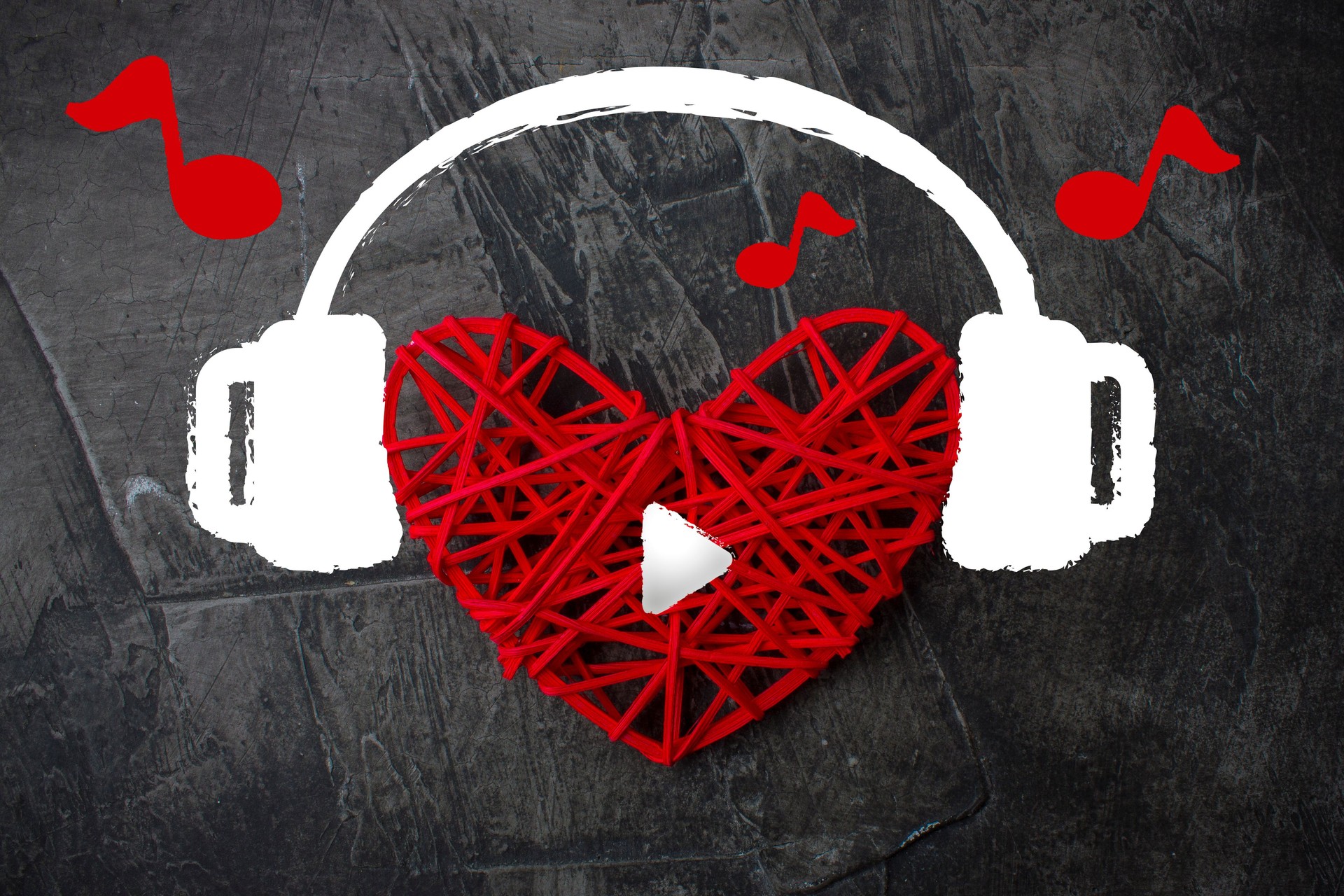 Heart in headphones on a dark background. Theme for Valentine's Day. Wedding, love